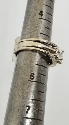 "We do not check prongs for wear or stones for looseness. All items are sold as is-noting that we are a resale shop so everything here had a previous owner! We will include flaws in the description when noted. This is one of the reasons our items are more affordable than new at a jewelry store. Vintage 14K White Gold Fused 3 Band Ring Set with 1 TCW Diamonds, Size 5.25. Stamped 14 KT and some lettering I can't make out. The Diamond(s) have been soft graded I1;I2 by the jewelry shop we use for re Silver Rings Stamped 14k With Round Cut, White Gold Stackable Emerald Cut Wedding Ring, Formal Stackable Emerald Cut Diamond Ring, Stackable Emerald-cut Diamond Anniversary Ring, Stackable Emerald Cut Diamond Anniversary Ring, Stackable Emerald Cut White Gold Rings, White Gold Emerald Cut Stackable Rings, Formal 14k White Gold Three Stone Jewelry, Formal Three Stone Ring Jewelry