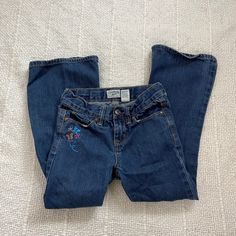 Love these late 90s / early 2000's era denim flare jeans for kids! Label: OshKosh B'Gosh Material: 100% Cotton Size: 6X Good Vintage Condition MEASUREMENTS IN INCHES (laid flat + unstretched double where needed) : Waist: 11.5 (adjustable waist straps inside jeans if you want to make it smaller) Length: 27 Each vintage piece has been preloved. Minor fading + wear is expected & often adds to the character. All items are cleaned & from a smoke & pet free building. We hope you appreciate this find as much as we do. 2000 Era, Jeans For Kids, 2000s Era, Y2k Early 2000s, Denim Flare Jeans, Kids Labels, Late 90s, Embroidered Denim, Denim Flares