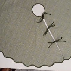 a pair of scissors sitting on top of a table next to a piece of cloth