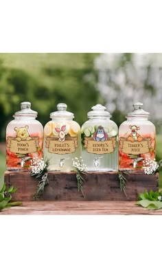 three jars filled with liquid sitting on top of a wooden box