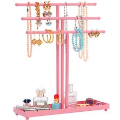 a pink jewelry rack with necklaces and rings on it