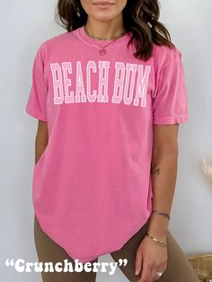 The ultimate Beach Shirt, get ready for Summer or Beachy Vacation with this cute Beach Bum Shirt! This Preppy Comfort Colors® Tshirt is super comfy! Size up for a Trendy Oversized Look! ♥ Hello and Welcome to Meaningful Tees Shop! ♥ Models are wearing Crunchberry, Chambray, Chalky Mint, Lagoon Blue, Island Reef, Washed Denim ♥ All of our items are made one at a time with care for each customer : ) ♥ Please allow 3-7 BUSINESS days (usually 3-5) for your item to be created PLUS shipping time via USPS ♥ UNISEX TEES fit like a Mens Shirt on Women, but are not overly large. ♥ For a RELAXED FIT, your usual size will typically work, but please consult the Size Chart in the Listing Photos ♥ For a TRENDY OVERSIZED FIT, size up 1, 2, or 3 Sizes! (2 sizes up is most common) ♥ For a SNUG FIT, size dow Pink Short Sleeve T-shirt For The Beach, Cute Pink T-shirt For Beach Season, Trendy Pink T-shirt For The Beach, Cute Pink Beach T-shirt, Trendy Pink Tops For The Beach, Short Sleeve T-shirt For Summer Activities, Pink Relaxed Fit T-shirt For Vacation, Beachy Tops For Beach Season, Cute Pink T-shirt For The Beach