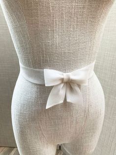 This lovely delicate bridal belt is beautifully hand made out of silk organza. It features center bow detail with the hanging tails. The belt is finished in the back with the hidden clasp. Available in white, off white or ivory, please see the last photo for the color reference. This belt measures 1 1/4" wide and the length is finished to your measurements.  * Please include your waist measurements in the notes during checkout and your belt will be finished at that length - If you would like to Bow Belt, Wedding Sash Belt, Wedding Belts, Bridal Belt, Silk Organza, Color Samples, Fabric Swatches, Wedding Accessories, Shop Design