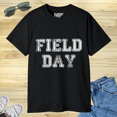 "Looking for a fun and exciting way to promote school spirit and teamwork? Look no further than our School Field Day design! Perfect for any school event or activity, this design is sure to get everyone in the spirit of friendly competition and camaraderie. With its bold colors and eye-catching design, our School Field Day graphic is the perfect way to show off your school pride and celebrate the power of teamwork. So why wait? Order your School Field Day design today and get ready to take your Pre K Field Day Shirts, Casual Back-to-school T-shirt With Funny Print, Field Day Shirts Design, Casual T-shirt With Funny Print For Back To School, Field Day T Shirts, School Field, School Event, Graphic Tee Shirt, Modern Feminine