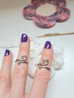 a woman's hand with two rings on it