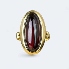 Introducing our exquisite Victorian Garnet Ring crafted in 9k yellow  gold weighing 5.8 grams. Adorned with a natural 4.5 ctw Garnet, this beautifully decorated ring is a perfect choice for an anniversary, engagement, or wedding. The radiant yellow finish adds a touch of warmth and sophistication, making it a timeless piece for her collection. Elevate your style with this unique and meticulously crafted ring, a celebration of love and elegance. Gold Oval Cabochon Sapphire Ring For Formal Occasions, Formal Gold Oval Cabochon Sapphire Ring, Gold Sapphire Ring With Oval Cabochon For Formal Events, Formal Gold Sapphire Ring With Oval Cabochon, Gold Ruby Ring Oval Cabochon With Polished Finish, Gold Domed Ruby Ring With Gemstone, Gold Ruby Ring With Domed Shape, Elegant Gold Garnet Cabochon Jewelry, Yellow Gold Oval Cabochon Rings For Formal Occasions