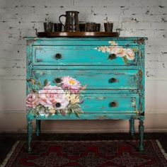 an old dresser with flowers painted on it