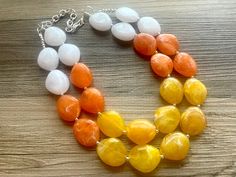 Candy corn (love it it hate it) is an undisputed sign of fall!  Dress up any outfit - great for a night out or with a white tee! 16 Inch Necklace with a 4 inch silver extender chain and silver lobster clasp. This is an eclectic bunch of acrylic beads in orange, yellow, and white. A total conversion starter!  Matching earrings found here:  https://polkadotdrawer.etsy.com/listing/1551978992 Thank you for supporting American small business! *Smoke and pet free home!* I ship 6 days a week! This part Jewelry Halloween, Orange Necklace, 16 Inch Necklace, Acrylic Jewelry, Jaune Orange, Jewelry White, Necklace Chunky, Fall Dress, Acrylic Jewellery