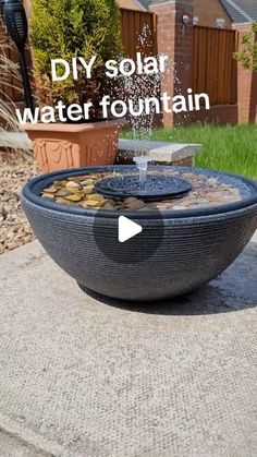 an outdoor fountain with rocks and water in it