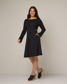 Effortlessly elegant—this sleek and structured dress features subtle details and a modern fit. - Easy boat neckline- Subtle long bell sleeves- Flattering waist seam- Full skirt- Hits below knee on most- Dress version of the Iris Bell Sleeve Top Sizing Tip: The Marnie is a fit & flare. Slim around the chest and waist, with a roomy, flared bottom. Easy Boat, Black Bell Sleeve Dress, Merino Wool Dress, Tunic Leggings, Structured Dress, Skirt Jumpsuit, Bell Sleeve Dress, Boat Neckline, Wool Dress