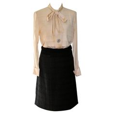 Offering a Silk Blouse and Wool Skirt ensemble. Skirt is 100% thick wool with a horizontal weave, and an all silk lining. Small pocket on right front. Skirt waist 28", length 22" approximate size 38-40. Cream white blouse with bow, three large mother-of-pearl buttons on front of blouse and one on each cuff. Length of blouse 26", sleeve 23". Approx EU size 38-40. Elegant Wool Skirt For Office, Elegant Wool Skirt For Formal Occasions, Luxury Silk Skirt For Workwear, Luxury Silk Skirt For Work, Silk Skirt For Workwear In Fall, Fall Silk Skirt For Work, Silk Workwear Skirt For Fall, Elegant Wool Pleated Skirt, Elegant Formal Wool Skirt Suit