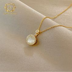 Introducing the epitome of timeless elegance, behold the Gold Necklace with a Pearl Pendant, adorned with a shimmering halo of zirconia stones. This exquisite piece marries the classic allure of pearls with the luxurious charm of gold, creating a mesmerizing fusion of sophistication and grace. At the heart of the necklace, a luminous pearl pendant takes center stage, exuding a timeless beauty that is both understated and captivating. The creamy luster of the pearl radiates with an ethereal glow, evoking a sense of purity and refinement. Surrounding the pearl, a delicate halo of zirconia stones adds a touch of sparkle and brilliance to the necklace, creating a dazzling frame that accentuates the beauty of the central gem. Each stone is meticulously cut and set to perfection, capturing the l Elegant Crystal Pearl Necklace With Pendant, Elegant Crystal Pearl Necklace For Formal Occasions, Elegant Formal Crystal Pearl Necklace, Elegant Yellow Gold Crystal Necklaces, Elegant Yellow Gold Crystal Necklace, Elegant Crystal Necklace With Pearl Pendant, Formal Crystal Pearl Necklace With Pendant, Timeless Gold Pearl Necklace For Wedding, Timeless Gold Pearl Necklace With Diamonds