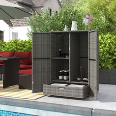 an outdoor furniture set next to a swimming pool