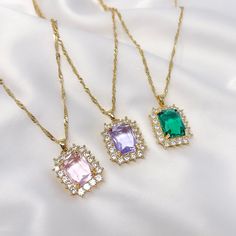 "This listing is for one resizable/adjustable pink, purple, or emerald green faceted rhinestone charm necklace with gold plated twist chain. This necklace is made with a brass base, gold plating, and a small gold plated stainless steel charm at the end of the extension chain. Chain is 16.5\" long with a 3.5\" extension. The maximum length of the necklace is 20\"." Adjustable Jeweled Crystal Necklaces, Cubic Zirconia Pendant Charm Necklaces With Adjustable Chain, Trendy Jeweled Jewelry Perfect As A Gift, Dangle Rhinestone Necklace For Gift, Trendy Crystal Necklaces With Jewels, Gift Rhinestone Charm Necklaces, Dainty Crystal Jewelry With Rhinestones, Trendy Jeweled Gold Jewelry, Purple Cubic Zirconia Necklaces For Party