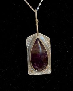 "Handmade sterling and deep purple amethyst necklace with a teardrop stone and shaped silver backplate.  Amethyst is a February birthstone, but this is fashionable all year round.  Pendant measures 1 3/8\" long and has a 3/4\" peanut shaped bail that is wrapped in fine silver wire.  Beautifully hand textured for extra shine and sparkle.   Comes with a 18\" sterling silver chain. Thank you for visiting Studio729!  I welcome your questions and business.  To see more of my handmade jewelry, just cl Handmade Spiritual Teardrop Drop Necklace, Spiritual Sterling Silver Teardrop Necklace, Spiritual Teardrop Large Stone Jewelry, Amulet Style Teardrop Gemstone Jewelry, Amulet Style Jewelry With Teardrop Gemstone, Sterling Silver Teardrop Amulet Necklace, Sterling Silver Teardrop Amulet Necklaces, Purple Teardrop Gemstone Necklace, Bohemian Teardrop Sterling Silver Drop Necklace