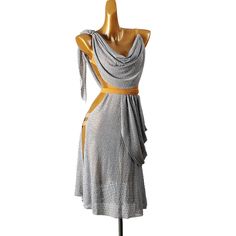 a dress on a mannequin with a yellow ribbon around the neck and shoulders