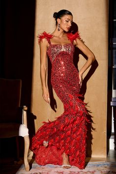 a woman in a red dress posing for the camera