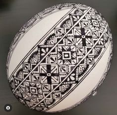 a black and white ball with geometric designs on it