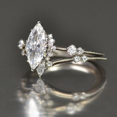 a close up of a diamond ring on a table