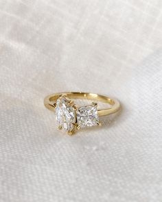 three stone diamond ring on white fabric