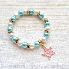 Cute starfish beaded stretch bracelet. Perfect gift for any animal lover for a birthday or a special gift. These are great gifts for little girls aswel as adults, you will find matching items in my store. *The bracelets are available for adults and children. Adults measure approximately 7.5inches unless a note is made. Children sizes vary depending on age of child. *The bracelets are made using 8mm glass pearl beads in any colours of your choice. which can be selected from the menu. *In between the beads are gold rhinestone beads to give a little sparkle.  *In the centre is a gold plated enamel starfish charm. *The charm measures approximately 2cms. ☆☆The bracelet comes presented in a little gift bag, I also have gift wrap and messages available to purchase from my store☆☆ If you have any Cute Starfish, Bracelet Ocean, Beach Bracelet, Starfish Bracelet, Beach Bracelets, Ocean Jewelry, Sea Animal, Gold Rhinestone, Rhinestone Bead