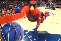 the mascot is playing basketball on the court