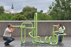 an older man and young boy playing with a sculpture