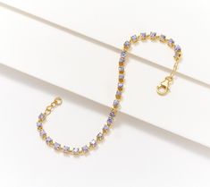 Round tanzanite gemstones bring winning color to a traditional, always stylish tennis bracelet design. Score! From Affinity® Gems. Classic Silver Gemstone Tennis Bracelet, Purple Gemstone Round Tennis Bracelet, Purple Gemstone Tennis Bracelet, Adjustable Cubic Zirconia Tennis Bracelet, Tarnish Resistant, Classic Tanzanite Multi-stone Jewelry, Tanzanite Gemstone, Bracelet Design, Tennis Bracelet, Bracelet Designs