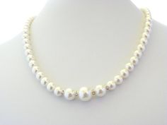 Beautiful beaded Wedding Necklace made of Swarovski Pearls. It is made of one strand of small pearls that get bigger in size at the front and is separated by silver spacers with clear crystals. It's a very romantic necklace that can be used for any bridal gown. The necklace measures approx. 18 inches, but can be made to your desired length (up to 22 inches). It ends with a small silver clasp.See last picture for matching earrings and bracelet available in my shop here: https://www.etsy.com/listi Single Strand Pearl Necklace For Wedding, Pearl Bridal Necklace For Wedding, Adjustable Single Strand Pearl Necklace For Wedding, Pearl White Beaded Necklace For Anniversary, Single Strand Beaded Necklace For Wedding, White Single Strand Necklace For Wedding, Pearl White Bridal Necklace For Bridesmaid Gift, Adjustable Single Strand Beaded Necklace For Wedding, Pearl White Beaded Necklaces With Pearl Drop For Wedding