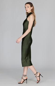 A classic bias cut dress with an elegantly draped high cowl neck. This sleeveless dress is cut in a flattering tea length with a clean baby hem finish. This dress is unlined and needs only a back neckline keyhole closure thanks to the nature of bias cut fabric. Silk Midi Slip Dress With Side Slits, Elegant Sleeveless Dress With Side Slits For Night Out, Fitted Silk Midi Dress With Asymmetrical Neckline, Chic Formal Silk Dress With Cowl Back, Chic High Neck Silk Midi Dress, Sleek Silk Dress With Bias Cut For Evening, Formal Sleek Slip Dress With Cowl Back, Sleek Midi Length Slip Dress For Formal Occasions, Elegant High Neck Sleeveless Formal Dress