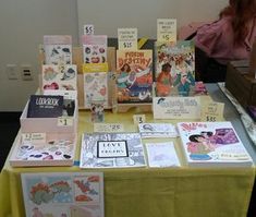 a table topped with lots of cards and books