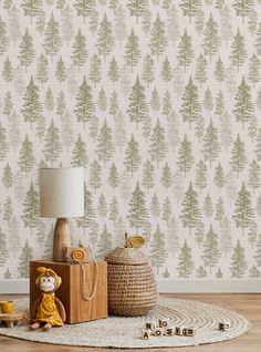 a room with a rug, lamp and wallpaper that has trees printed on it