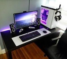 a desk with a computer and speakers on it