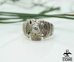 Metal: 14k White Gold (tested) Weight: 11.8 grams Ring Size: 8.25 (US) *This handsome ring is composed of 14k White Gold with the Masonic Double-Headed Eagle encrusted with a Diamond center stone and decorated with Masonic symbols of the Cross and Pyramid on the shoulders and an engraving on the inside of the band dated Nov. 18, 1904. A great gift for the your fraternal brother or father, don't let this vintage piece slip away! Silver Diamond Engraved Signet Ring, Formal Sterling Silver Engraved Diamond Ring, Antique Silver 14k Gold Diamond Ring, Antique Silver Diamond Ring In 14k Gold, Antique Silver-colored 14k Gold Diamond Ring, Formal Silver Signet Ring Stamped 14k, Silver 14k Stamped Signet Ring For Formal Occasions, Silver Signet Ring With Center Stone In 14k Gold, Art Deco Silver Signet Ring