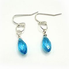 Elegant dangle earrings, a stunning combination of blue glass and silver French style ear wire. These exquisite earrings measure approximately 1 inch in length. The blue glass is 5mm in width. The wire is silver-plated. Add a touch of sophistication to any outfit with these captivating earrings. Please note that it is recommended to review all information provided before making your purchase. Care Instructions: ★Do not wear jewelry while swimming or bathing/showering. ★Keep jewelry in a dry loca Blue Wire Wrapped Drop Earrings, Blue Teardrop Crystal Earrings With Ear Wire, Blue Sterling Silver Earrings With French Hook, Sterling Silver Blue French Hook Earrings, Minimalist Blue Wire Wrapped Earrings, Blue Crystal Earrings With Lever Back For Gift, Blue Drop Earrings With Ear Wire, Blue Drop Earrings Hypoallergenic, Blue Nickel-free Long Drop Teardrop Earrings