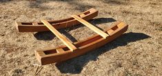 two wooden canoes laying on the ground