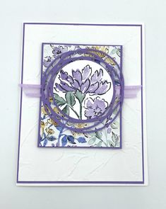 a purple and white card with flowers on it