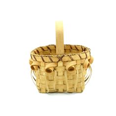 a small wooden basket with handles on a white background