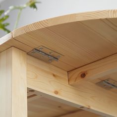 a close up of a wooden bench with metal brackets