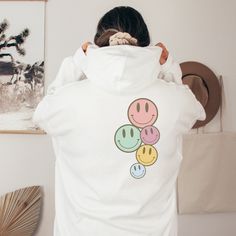 Time for a new Hoodie, and some new vibes! Pastel Smiley Face hooded sweatshirt  On trend, preppy Clean Girl aesthetic hoodie for school, lounging, or walking the beach enjoying the breeze. Exclusively designed by Parcel 23. Direct to garment printed in the USA (this is not a transfer, it's the real deal). Link for T-shirt option: https://www.etsy.com/listing/1548977185/oversized-comfort-colors-have-the-day Select your size and favorite color option, and we'll have it produced and delivered in a Playful White Hoodie For Streetwear, Playful Graphic Print Hoodie Sweatshirt, Playful White Hoodie Sweatshirt, Playful White Hoodie With Drawstring Hood, Playful White Hooded Sweatshirt, Playful White Cotton Hoodie, White Graphic Print Hoodie For Loungewear, Playful Hoodie With Drawstring Hood For Streetwear, Playful Streetwear Hoodie