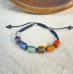 "Free Shipping when you spend $35 at Moondance Trading. Our Products are the same as shown in the pictures. We do not use substitute images. Shapes, sizes, and colors may slightly vary. Everything ships directly from our studio in Orlando, FL. USA Made with Genuine Chakra Crystals: Jasper, Carnelian, Tiger Eye, Aventurine, Sodalite, Amethyst, Clear Quartz. These adjustable unisex bracelets fit best 7.5\" to 9\" wrist sizes. Size, color and shape of the bracelets may slightly vary. * Healing Info Dog Collar Charms, Chakra Healing Crystals, Unisex Bracelets, Evil Eye Charm, Chakra Crystals, Chakra Healing, Orlando Fl, Healing Crystal, Adjustable Bracelet