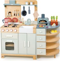 a toy kitchen with an oven, sink and stove top cooking utensils on the counter