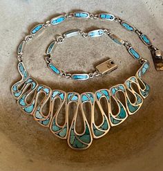 Gorgeous Taxco 925 sterling silver turquoise inlay Mexican bib necklace  Measures: 17 inches long by 1 1/2 inches at its widest point and weighs 60 grams  Marked: Taxco Mexico AMC and the TAXCO Sterling Silver registration number absolutely beautiful!! Vintage Mexican Jewelry, Mexican Jewelry, Jewelry Turquoise, Bib Necklaces, Vintage Mexican, Bib Necklace, Silver Turquoise, Turquoise Sterling Silver, Turquoise Jewelry