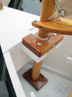 a wooden pole on top of a boat in the water