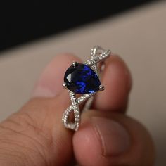 This is a gorgeous handmade creation. Its beauty is its simplicity & Elegance. The 7*9 mm pear shape faceted lab sapphire is crafted in solid sterling silver and with rhodium plated. All item is sent in a beautiful gift box If you have any idea of design your ring,pls contact me directly. You can realize more lovely stuff clicking the link https://www.etsy.com/shop/knightjewelry?refshopsection_shophome_leftnav Please leave the correct address and you phone number for delivering successfully. Pear-shaped Sapphire Ring, Fine Jewelry Pear-shaped Sapphire Ring, Blue Pear-shaped Sapphire Ring, Blue Pear-shaped Sapphire Ring With Accent Stones, Blue Sapphire Pear-shaped Ring, Pear-shaped Blue Sapphire Ring, Blue Pear-shaped Sapphire Ring With Cubic Zirconia, Pear-shaped Lab-created Sapphire Jewelry, Teardrop Blue Sapphire Ring With Diamond