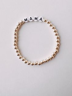 Meet our new Gold Beaded Mama Bracelet! Perfect for embracing motherhood in style! Great gift for moms and mom figures in your life! Elegant Beaded Bracelets With Letter Beads For Gift, Elegant Beaded Bracelets With Letter Beads As Gift, Mother's Day Gift Stretch Bracelet With 8mm Beads, Rose Gold Bracelets With 8mm Beads For Gift, Elegant Charm Bracelet With Letter And Round Beads, Rose Gold 8mm Beads Bracelet For Gift, Rose Gold 8mm Beads Bracelet As Gift, White 8mm Bead Jewelry For Personalized Gifts, Personalized White Jewelry With 8mm Beads