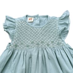 The Pastel Mint Smocked Dress embodies the essence of springtime freshness and effortless charm. It has deliciated hand smock from shoulder to chess, suitable for both formal and casual occasions.  * 100% Cotton * 100% Handmade * Tie at the back * Soft cotton, comfortable, and ready to play * Hand wash or machine wash on a delicate setting We are based in Sydney, New South Wales, Australia. We ship within Australia and to other countries as well. The shipping fee is vary based on the destination Ruffle Sleeve Dress With Smocked Back For Garden Party, Spring Dresses With Smocked Bodice And Ruffle Sleeves, Spring Dress With Smocked Back And Ruffle Sleeves, Summer Cotton Smocked Dress With Flutter Sleeves, Sundress With Smocked Bodice For Gatherings, Cotton Smocked Dress With Flutter Sleeves And Ruffles, Garden Party Smocked Dress With Ruffle Hem And Sleeves, Flutter Sleeve Smocked Dress With Ruffles For Garden Party, Flutter Sleeve Dress With Smocked Bodice For Garden Party