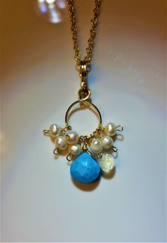 "Beautiful handmade Turquoise Pendant Necklace with a Lovely Turquoise Faceted Heart Briolette, a Faceted Pear Moonstone and Small Baroque Freshwater Pearls dangling from a beautiful handmade uniquely designed bail and pendant made of 14k gold filled wire. Please see the drop down menu for chain lengths. The 18K Gold Filled Chain is available in 16\" inches, 18\" inches, 20\" inches or 22\" inches. .Total length is approximately 1 1/2 inches (3.8 cm), and the circles are about 1/2 inch (1.3 cm) Handmade Turquoise Briolette Jewelry, Turquoise Multi-stone Round Necklace, Turquoise Multi-stone Pendant Necklace As Gift, Turquoise Gold-plated Necklace With Adjustable Chain, Artisan Blue Turquoise Multi-stone Necklace, Luxury Artisan Multi-stone Turquoise Necklace, Turquoise Pendant Necklace, Moonstone Necklace, Turquoise Pendant