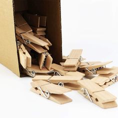 a cardboard box filled with lots of pieces of wood cut in half and tied together