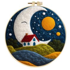 an embroidery kit with a house and moon on it